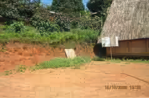 An outdoor area with dirt ground, a green hillside, a thatched-roof structure, and a white sign. Date stamp: 16/10/2008 13:53.