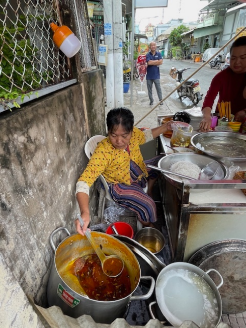 Mrs. Bich Ngoc, one of the beneficiaries, manages a breakfast food stall supported by the USAID project.